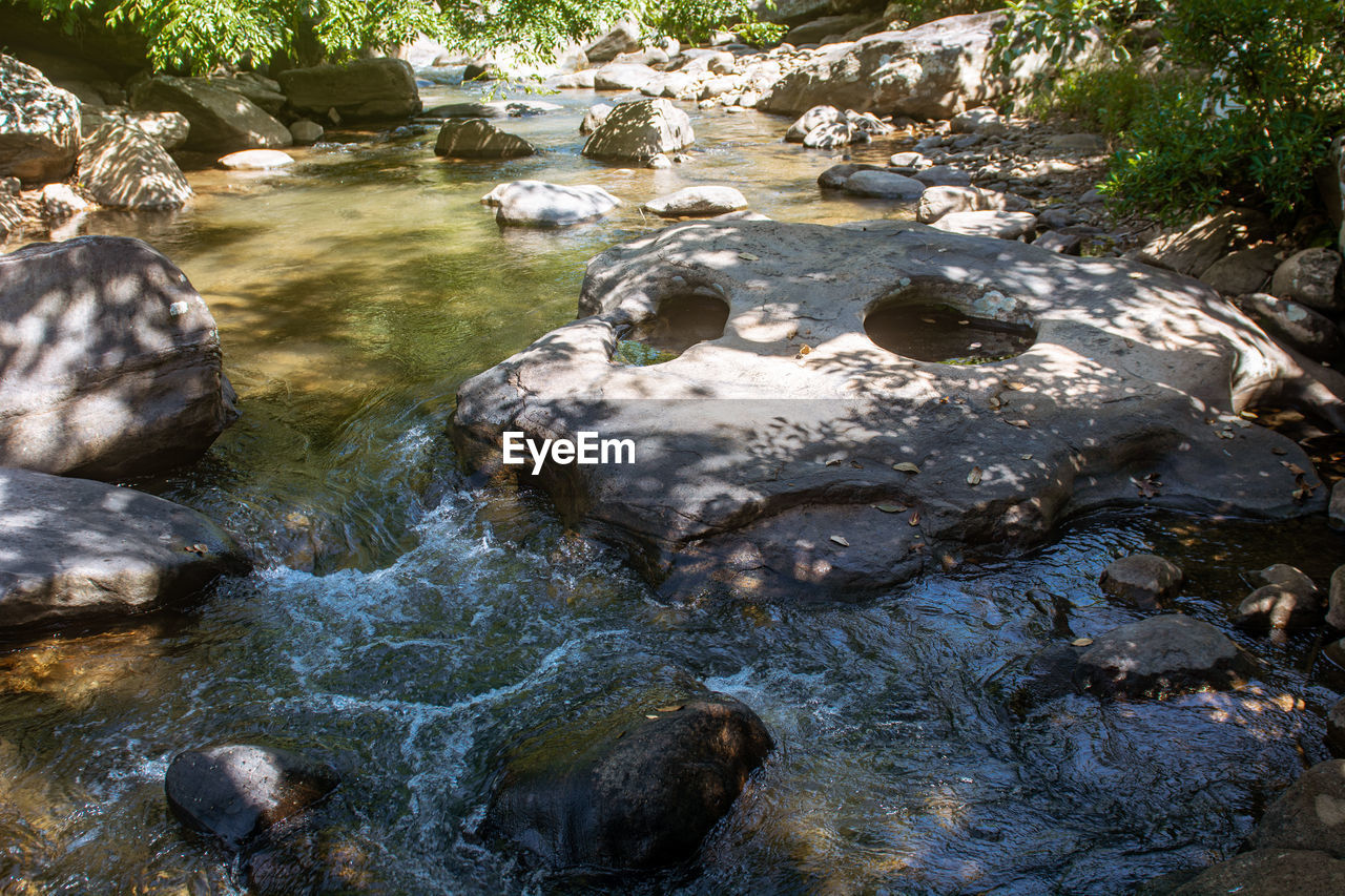 stream, water, river, rock, nature, body of water, watercourse, creek, rapid, beauty in nature, stream bed, no people, wilderness, tree, water feature, day, plant, flowing water, land, outdoors, scenics - nature, tranquility, forest, sunlight, environment, high angle view, autumn, non-urban scene, pond, motion, flowing