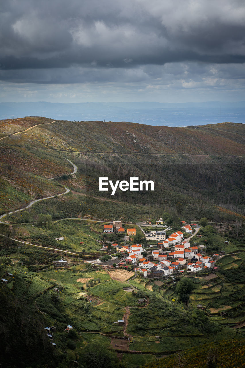 High angle view of houses on landscape against sky