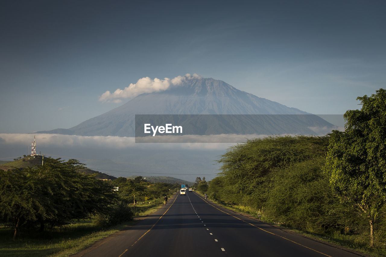 ROAD LEADING TOWARDS MOUNTAINS AGAINST SKY