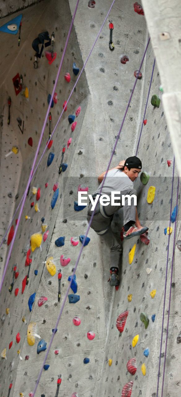 Full length of boy climbing on wall