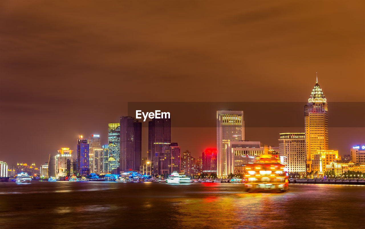 ILLUMINATED BUILDINGS AT WATERFRONT