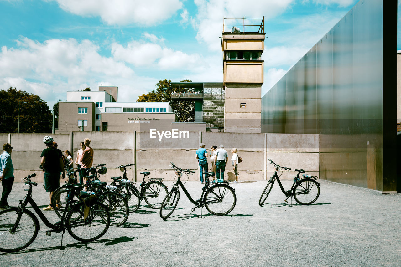 MAN RIDING BICYCLE ON WALKWAY