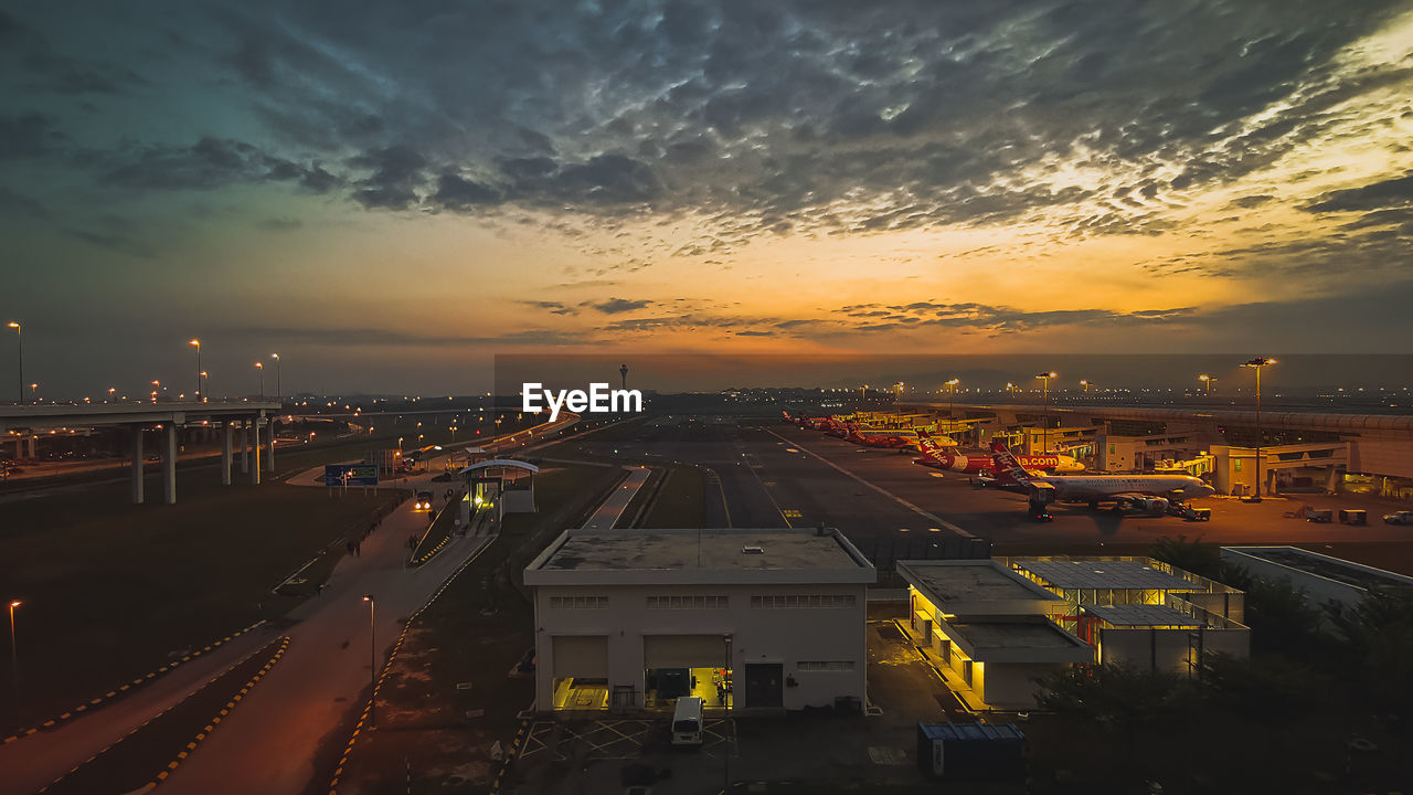 HIGH ANGLE VIEW OF CITYSCAPE DURING SUNSET