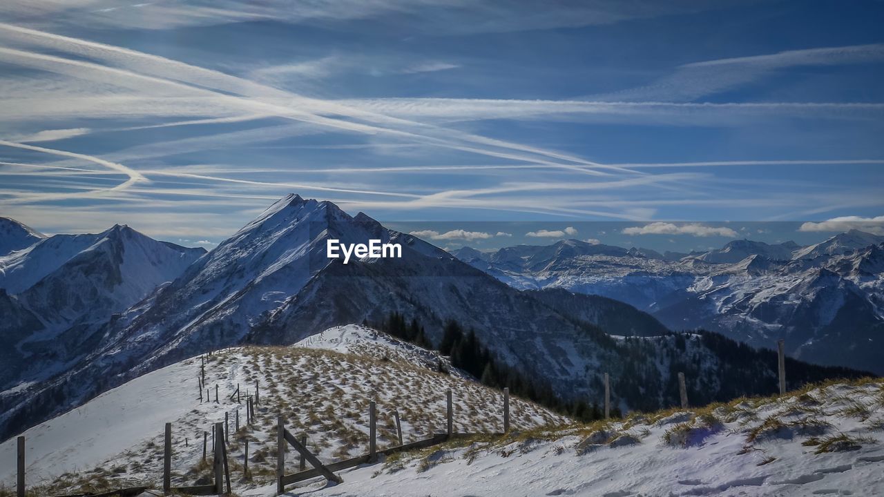 Scenic view of snow covered mountains against sky