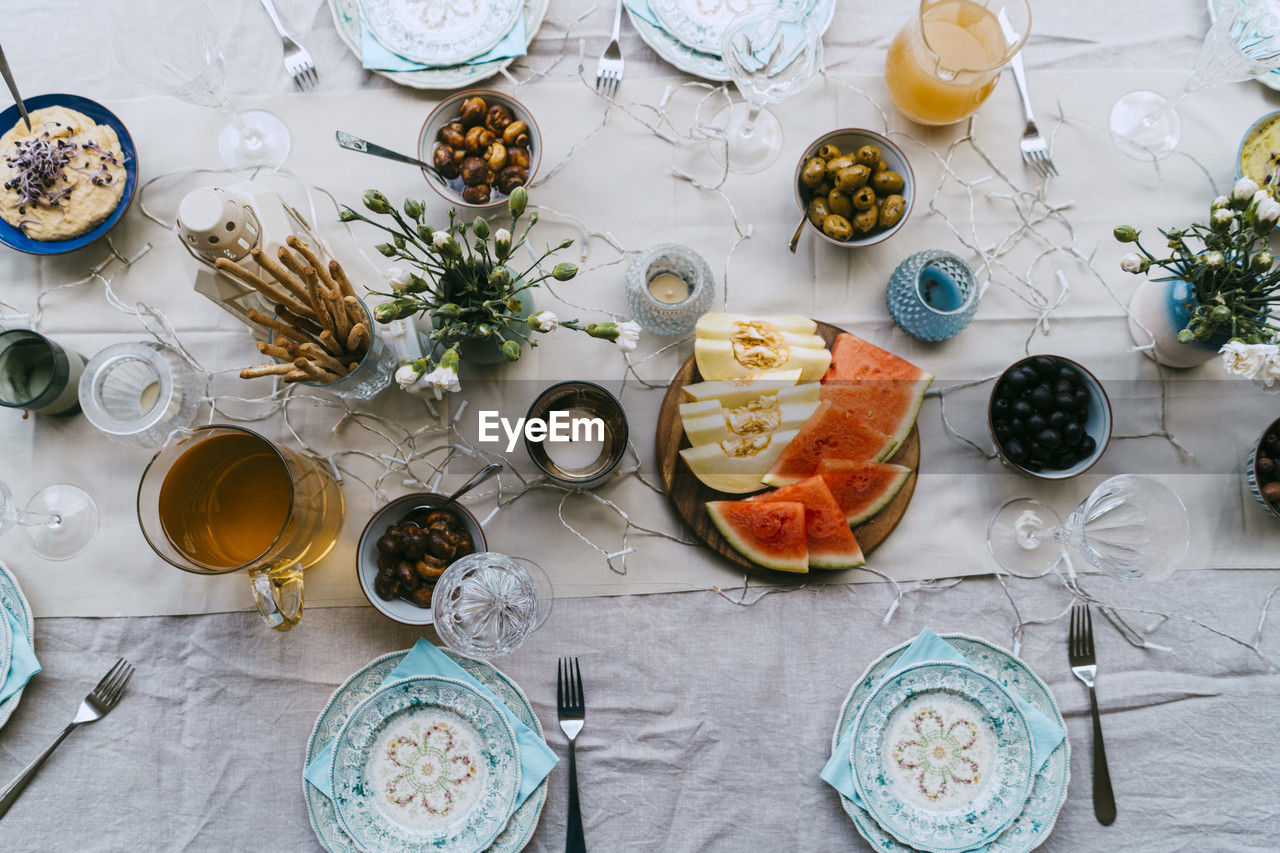 Directly above shot of fresh fruits and drinks arranged on table