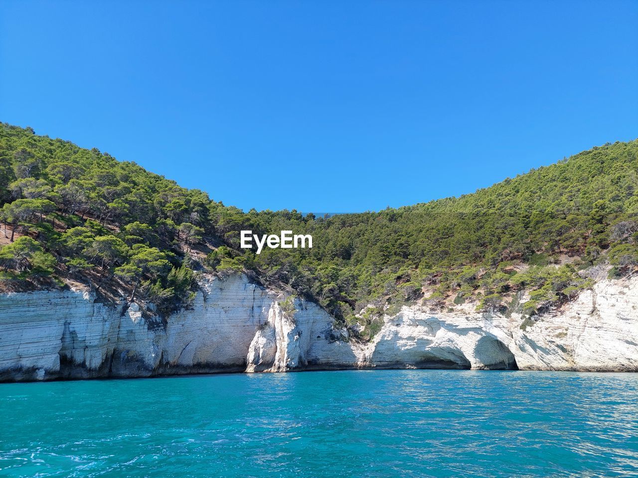 Scenic view of sea against clear blue sky