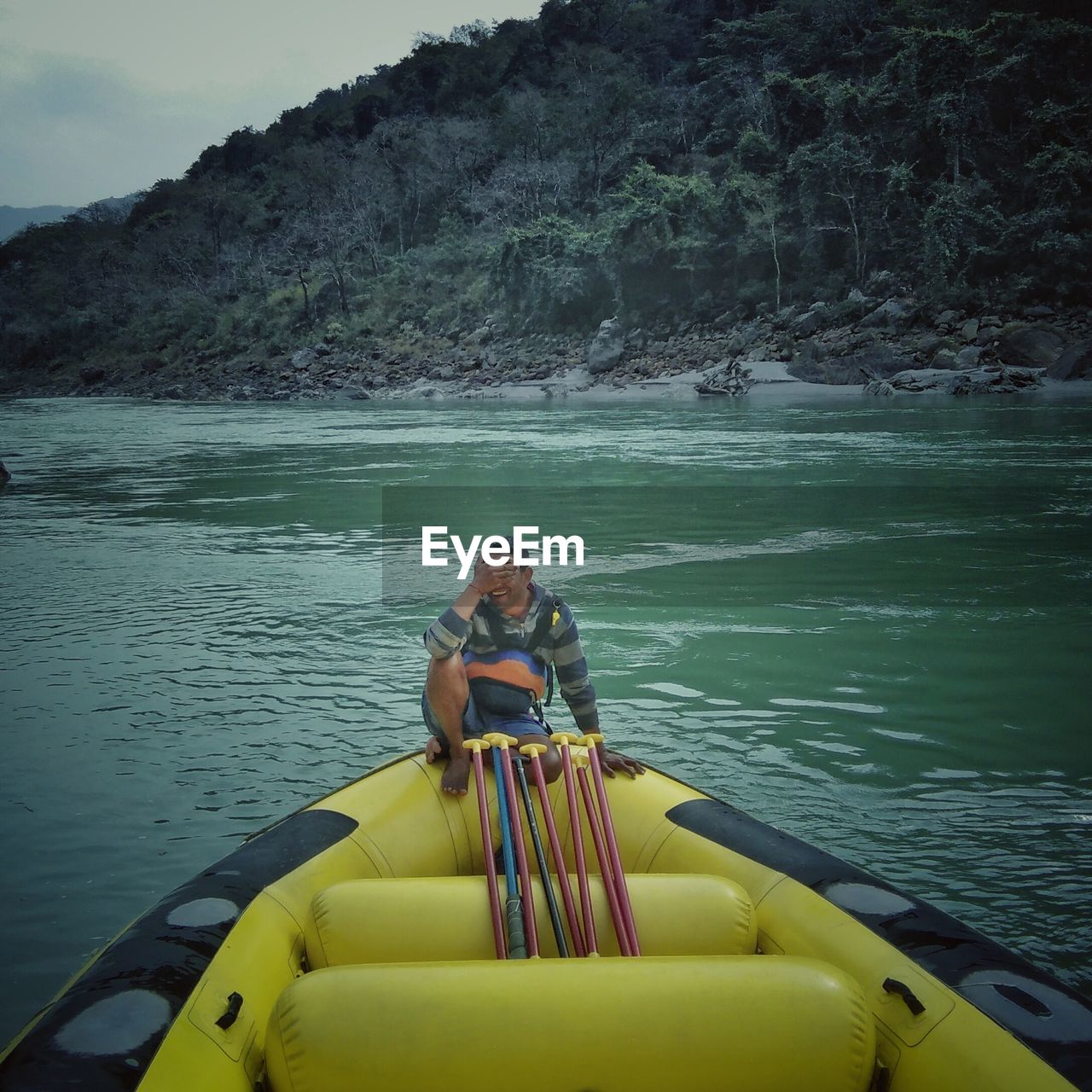 VIEW OF PEOPLE SITTING ON BOAT