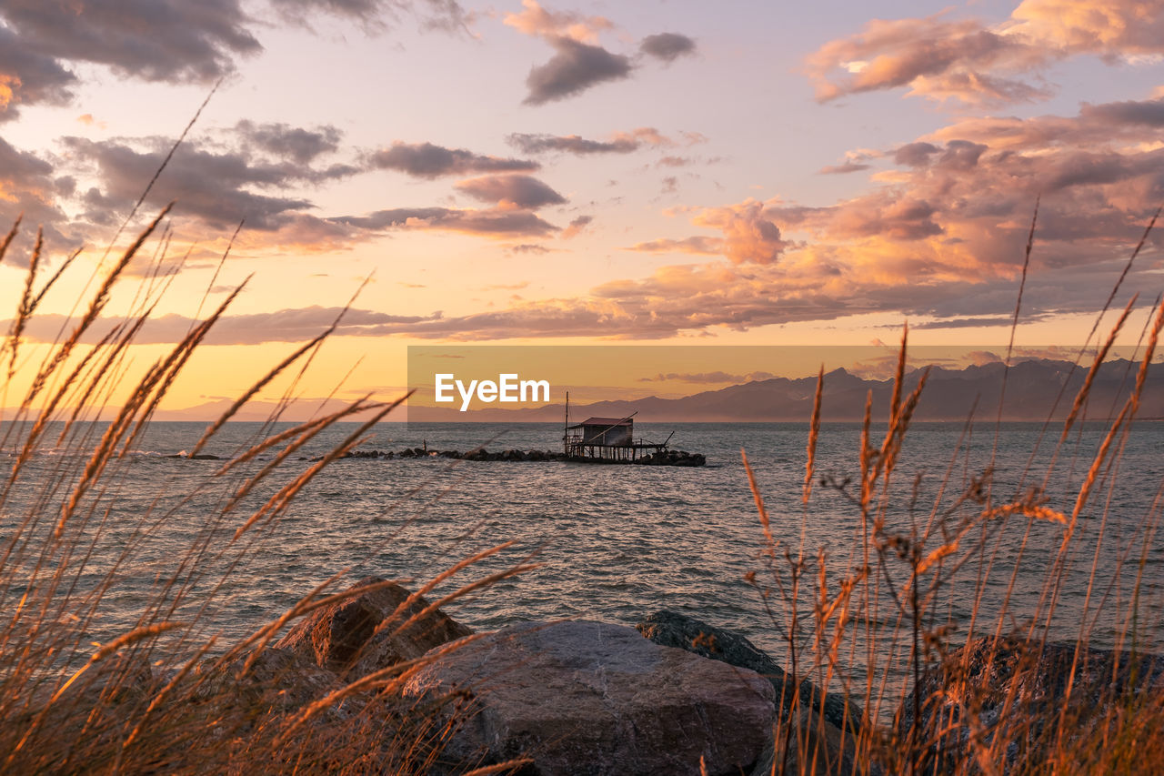 SCENIC VIEW OF SEA DURING SUNSET