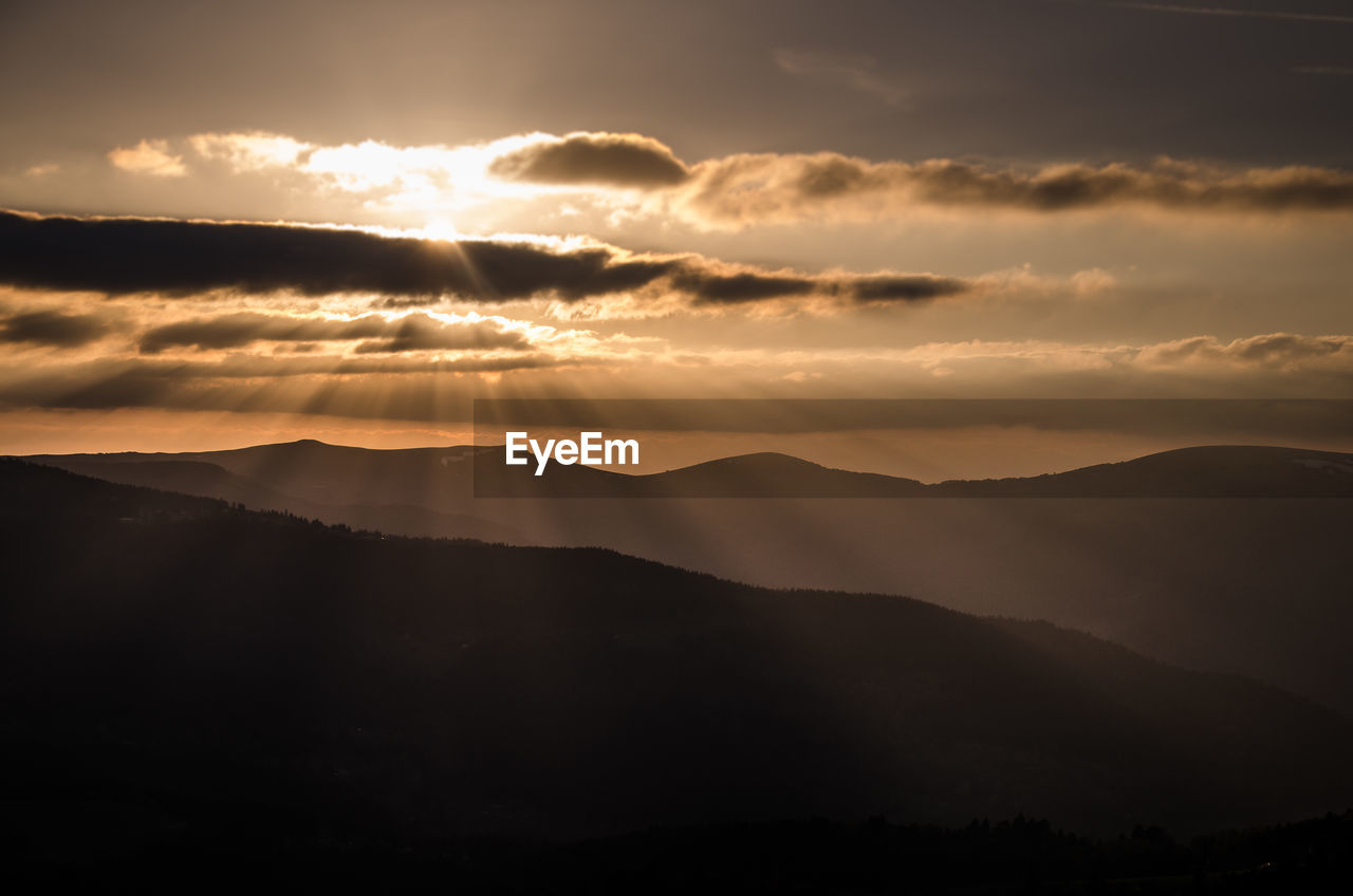 Scenic view of silhouette mountains against sky at sunset