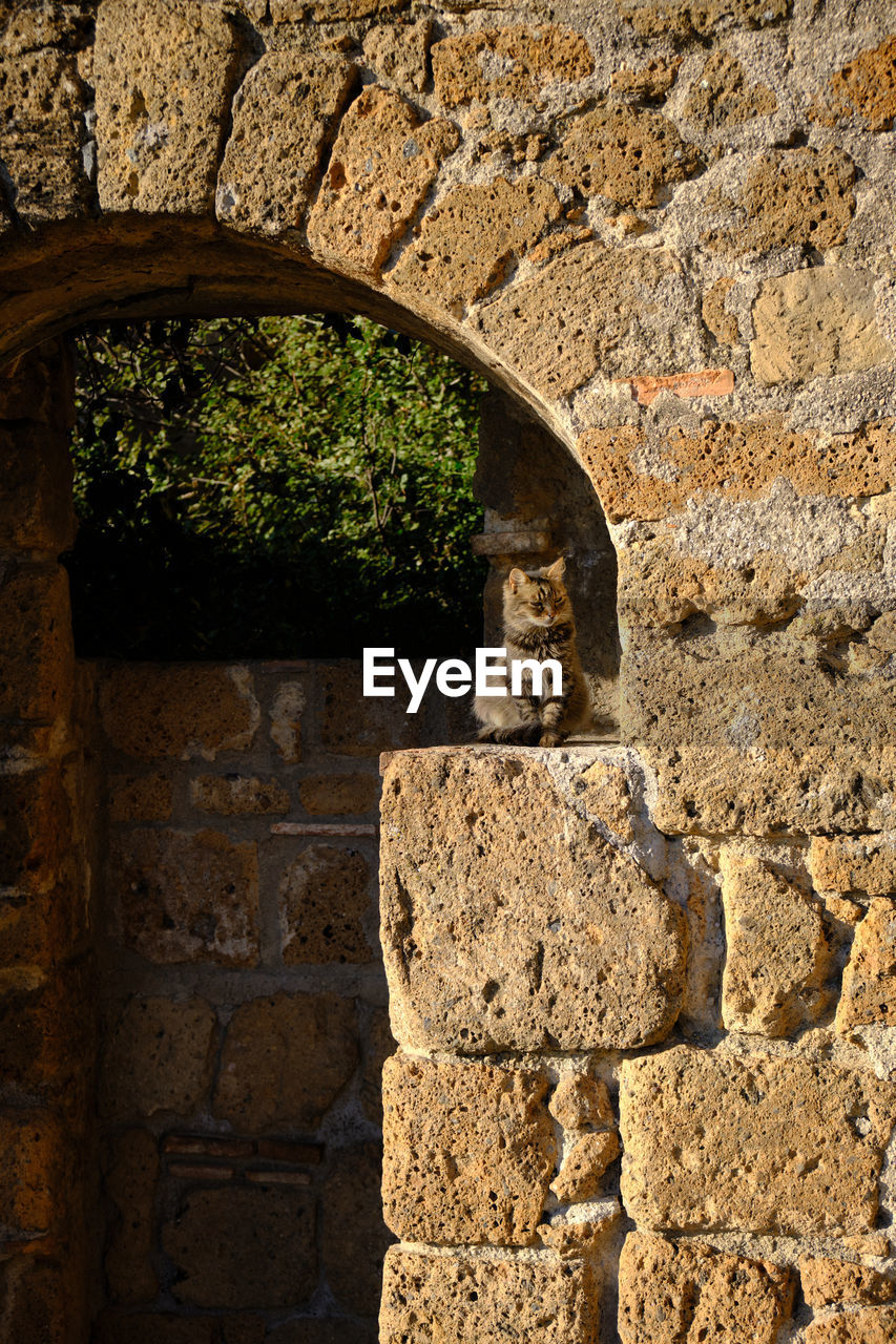 STONE WALL WITH OLD BUILDING