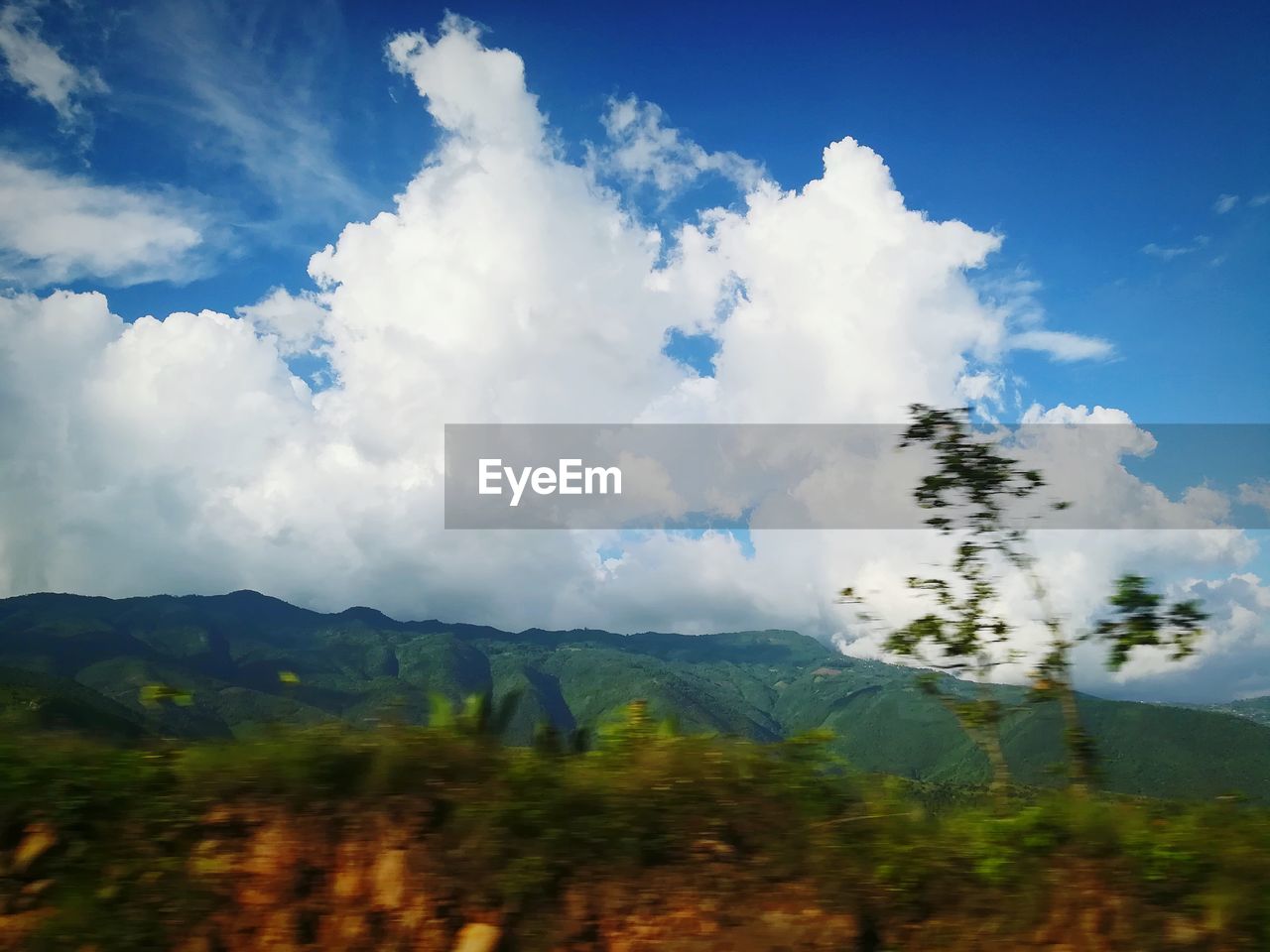 SCENIC VIEW OF LANDSCAPE AND MOUNTAINS AGAINST SKY