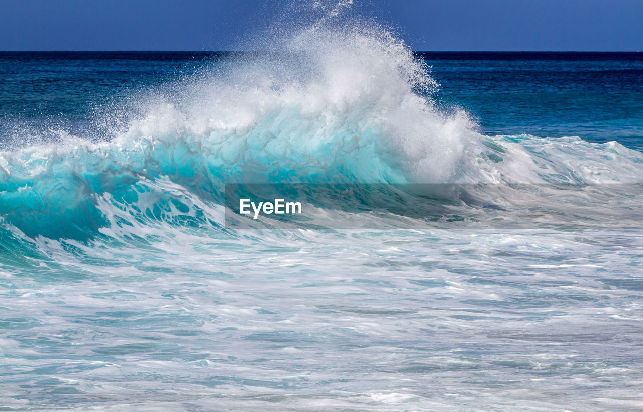 Waves breaking against sea