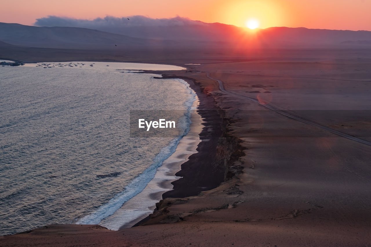 Scenic view of beach against sky during sunset