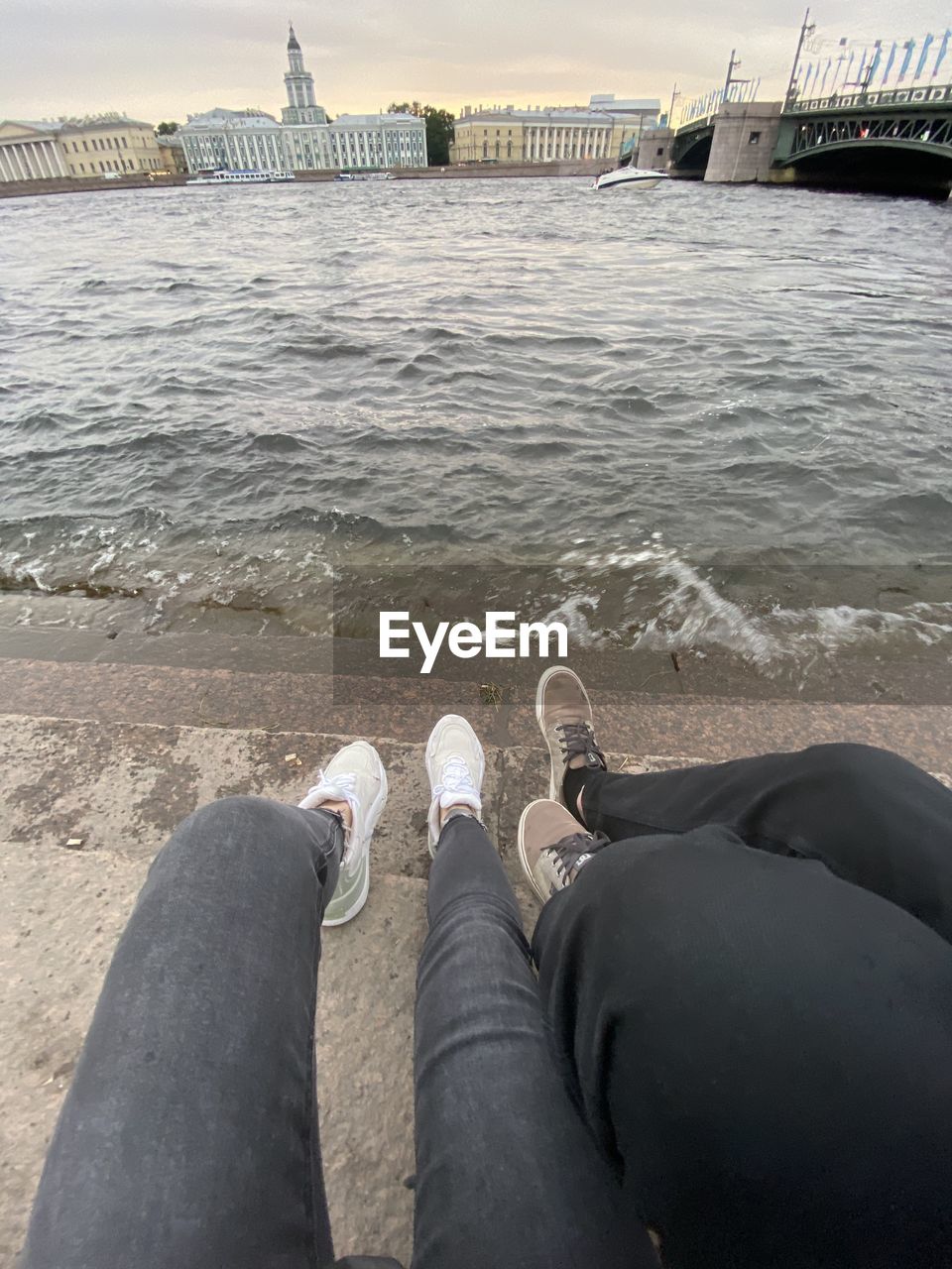 LOW SECTION OF PERSON RELAXING AT BEACH