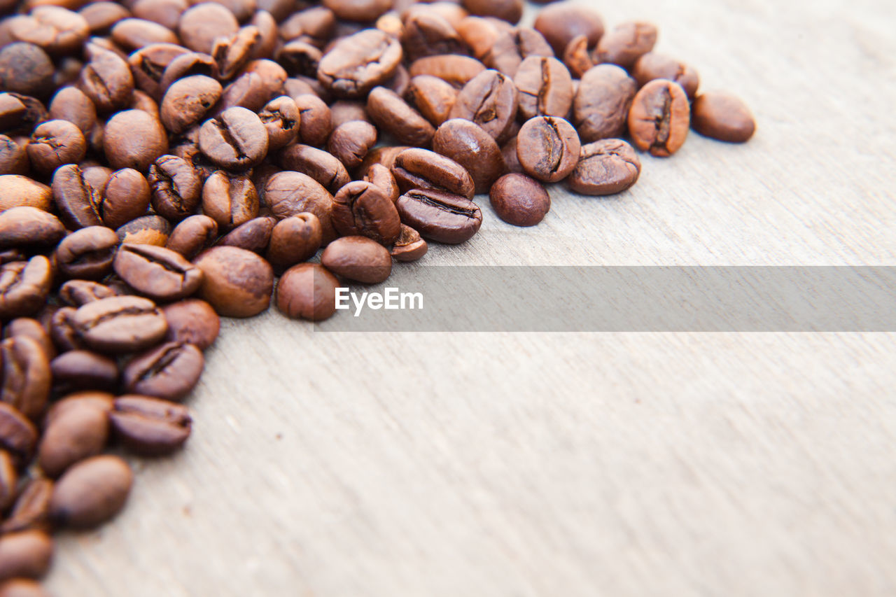 Roasted coffee beans on wooden table