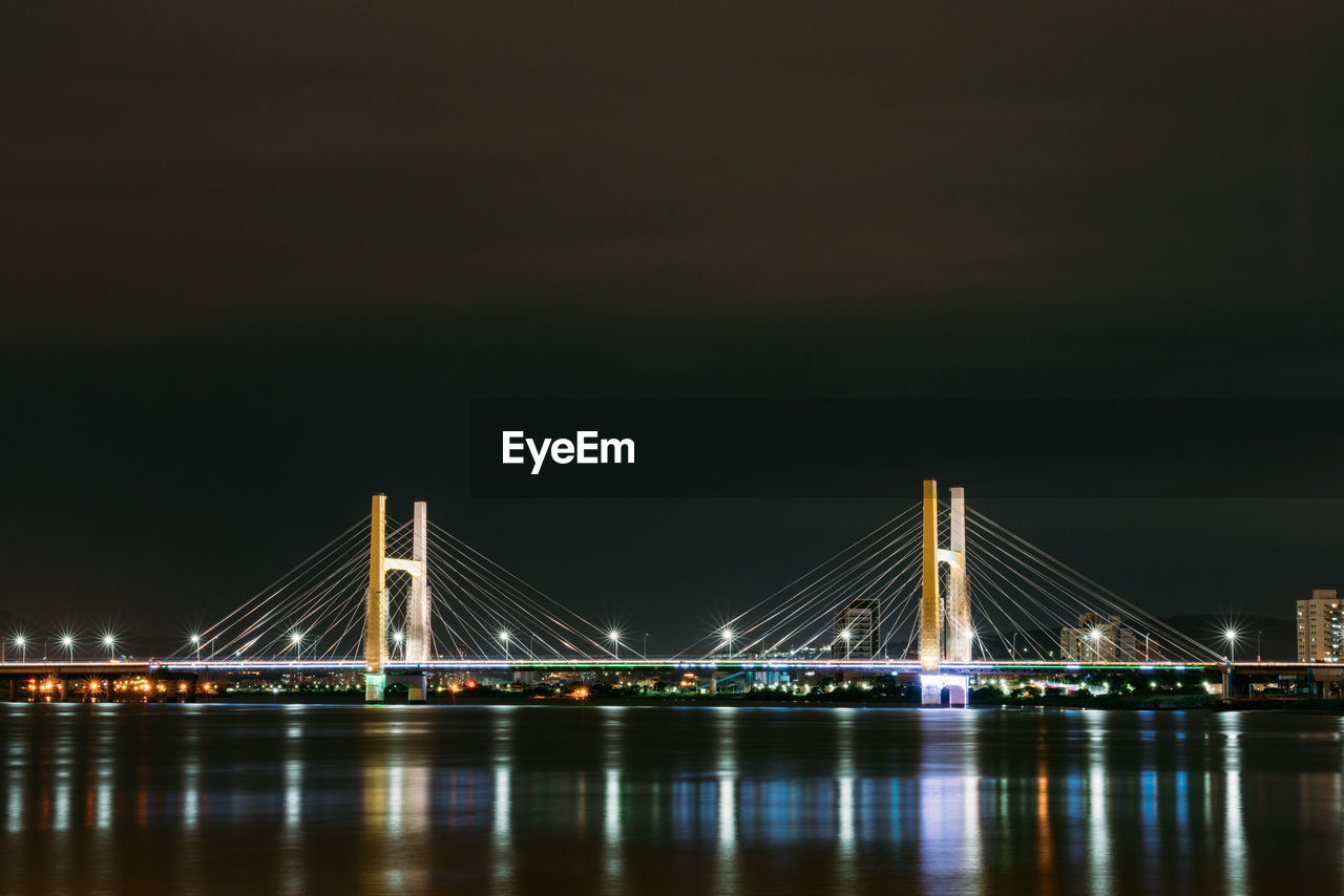 Illuminated suspension bridge at night