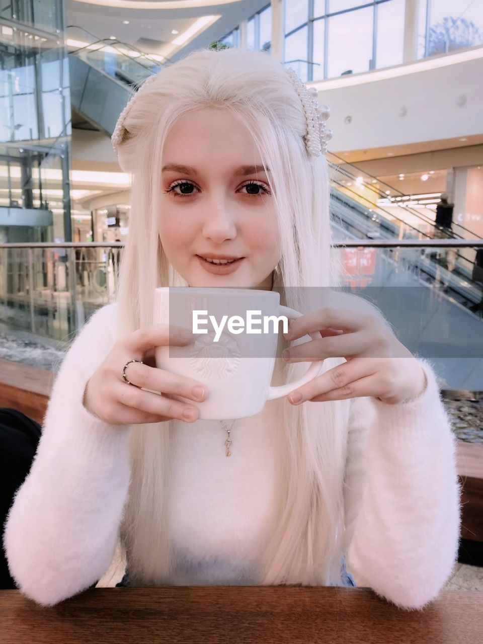 Portrait of a young woman drinking coffee