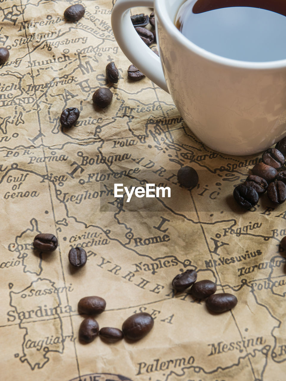 HIGH ANGLE VIEW OF COFFEE CUP ON TABLE WITH TEXT