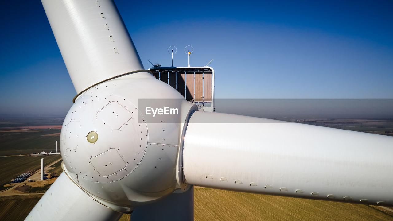 Aerial view of part of windmill turbine in countryside, green energy