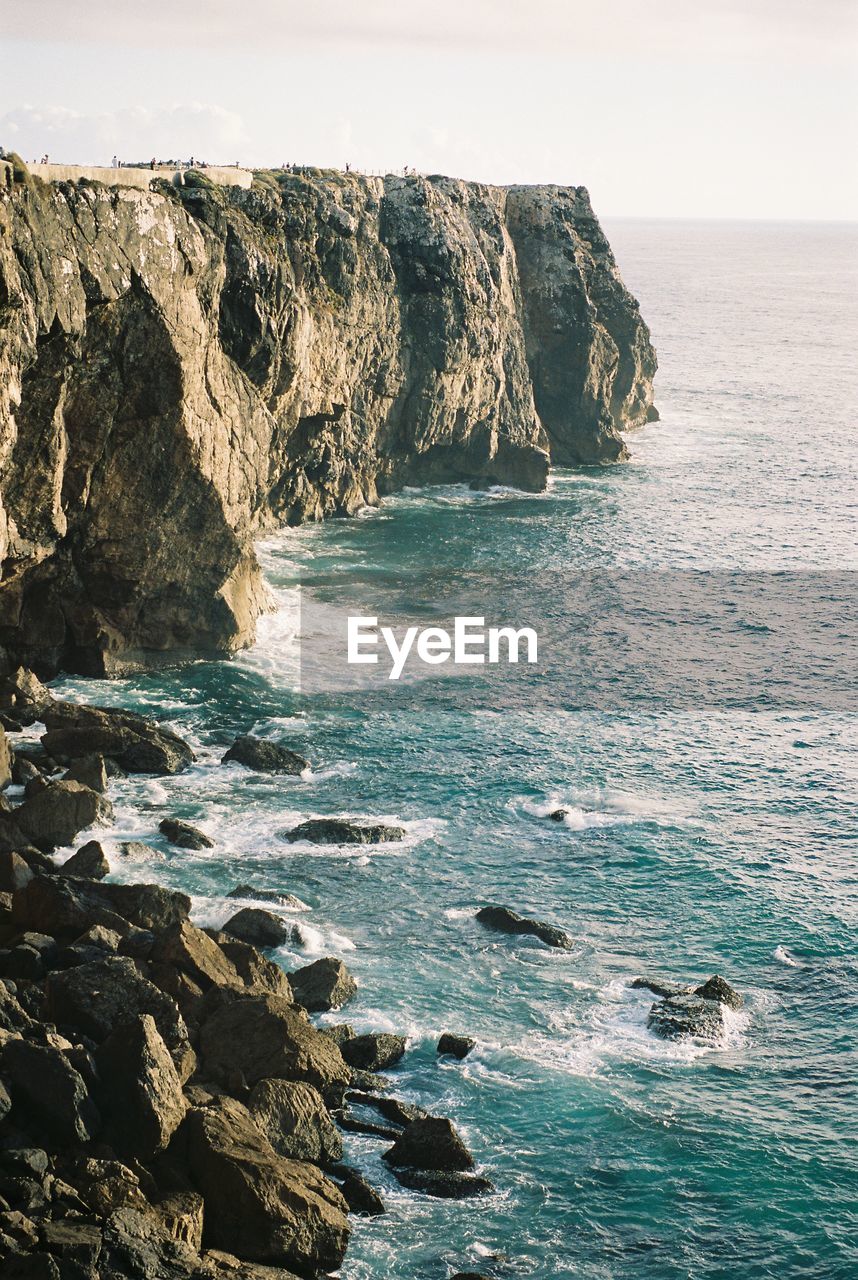 Scenic view of rocks in sea against sky