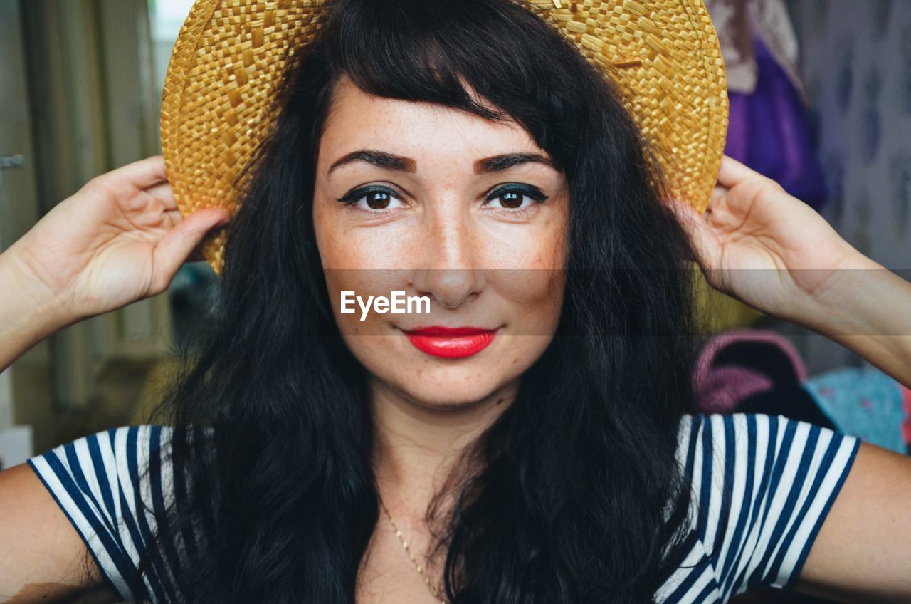 Close-up portrait of woman wearing hat