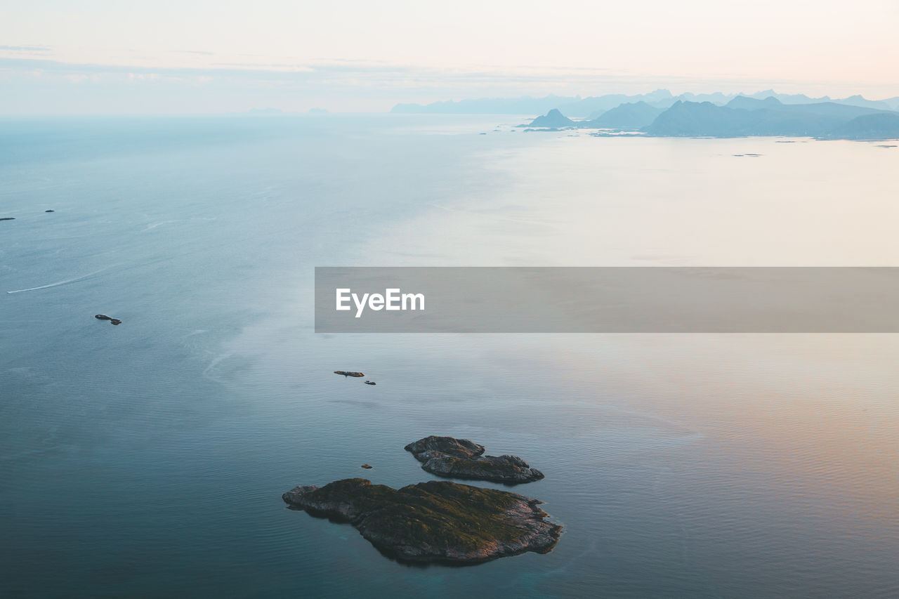 High angle view of rocks in sea against sky