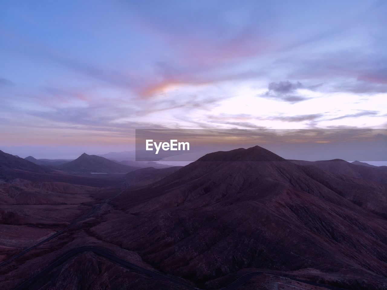 Scenic view of mountains against sky during sunset