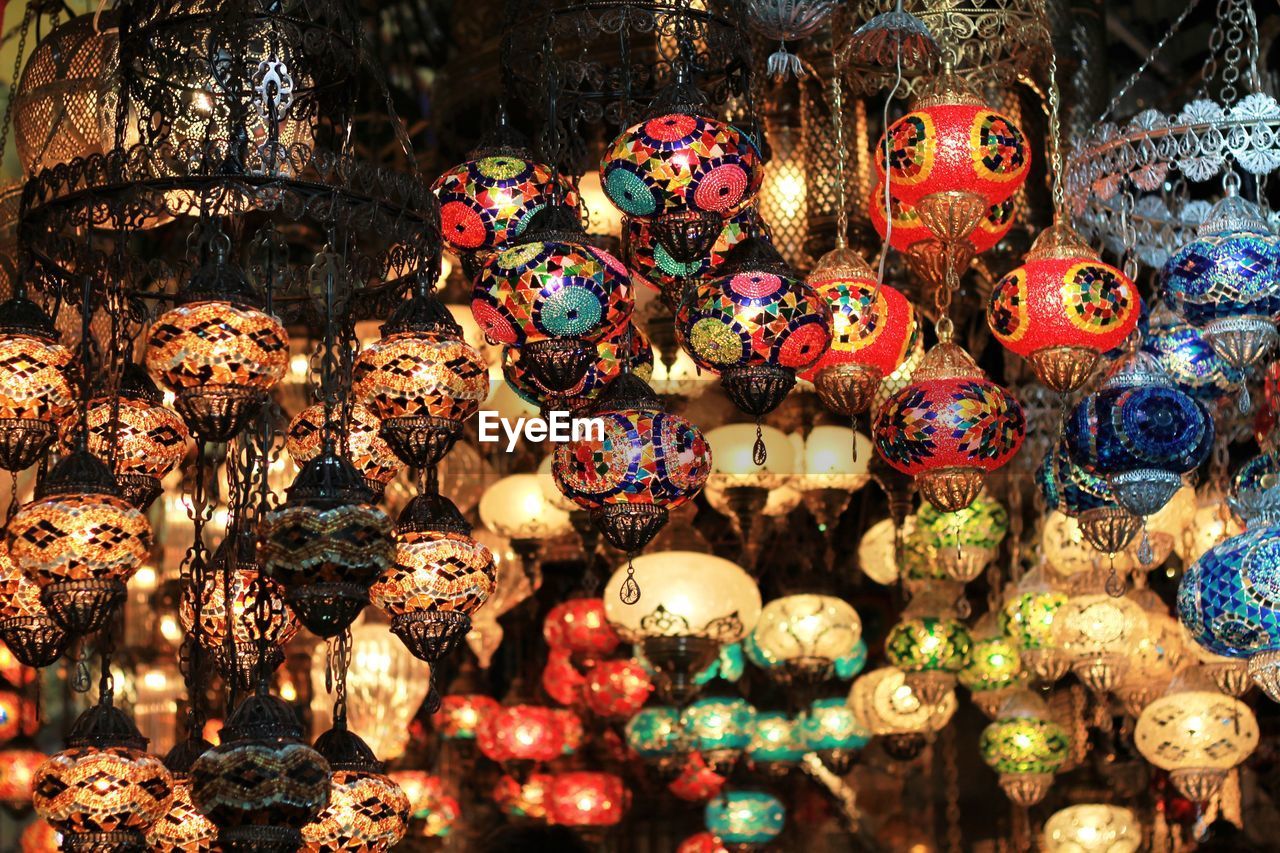Illuminated colorful lanterns hanging at antique shop