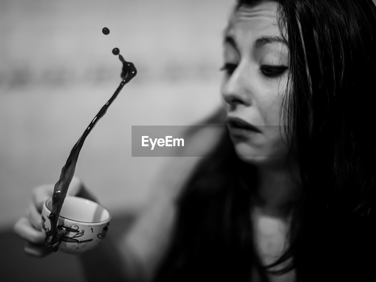 Close-up of young woman with coffee