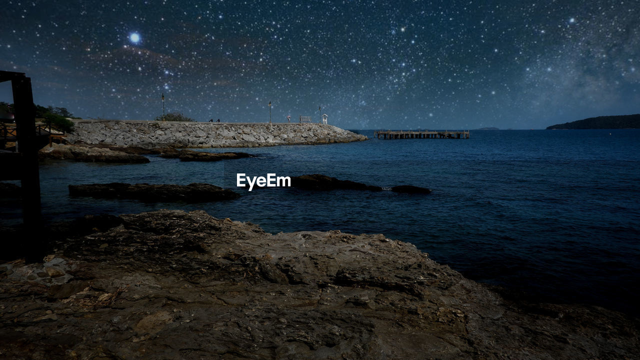 Scenic view of sea against sky at night