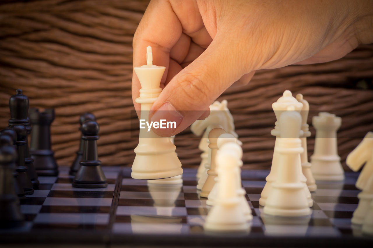 Close-up of hand playing chess 