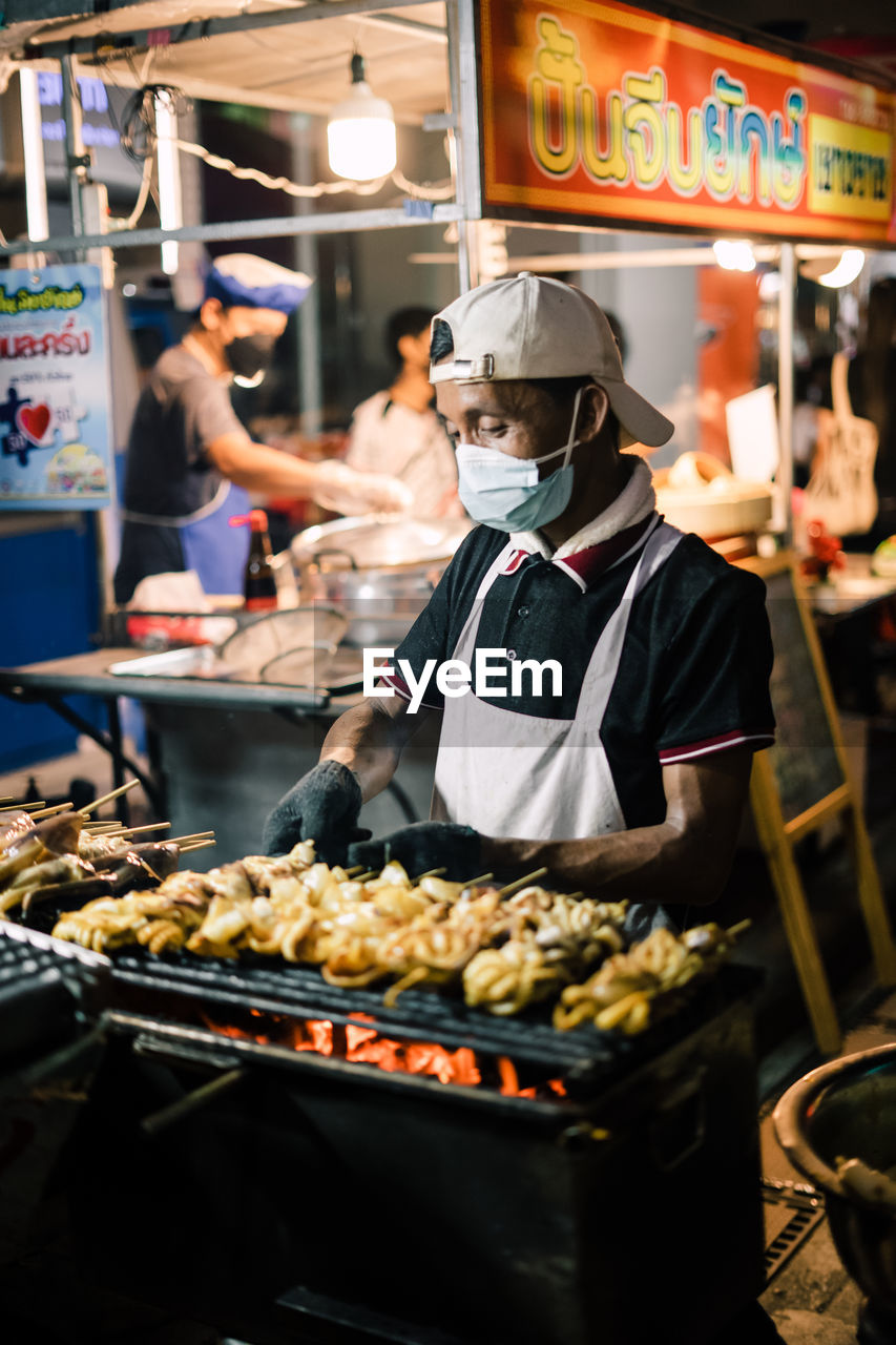 Man preparing food at market