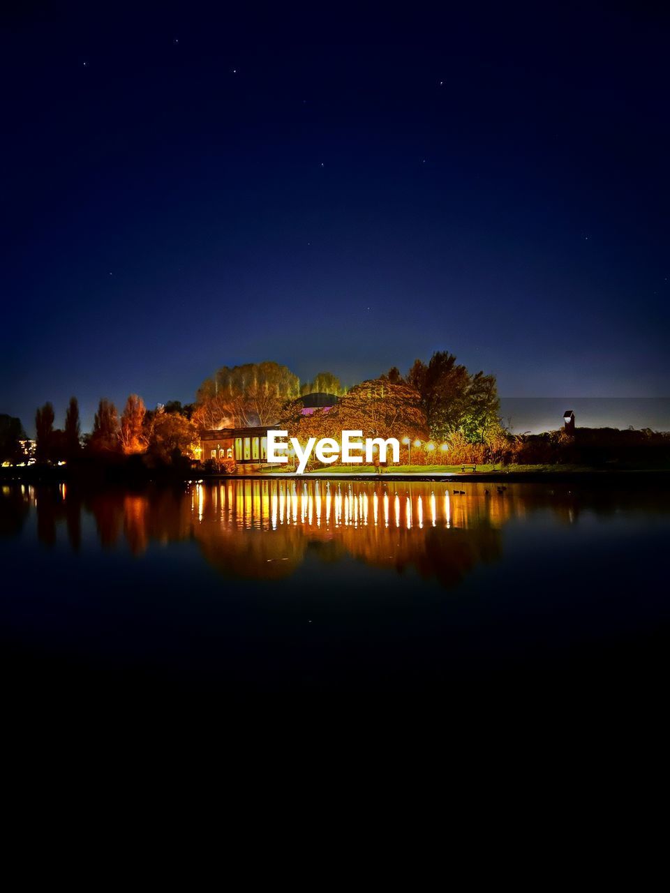 scenic view of river against sky at night