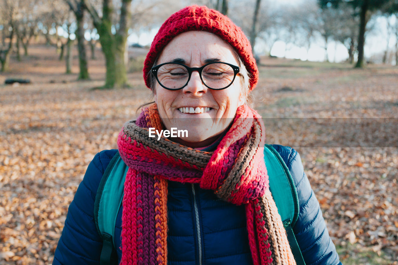 Woman wearing knit hat standing on field