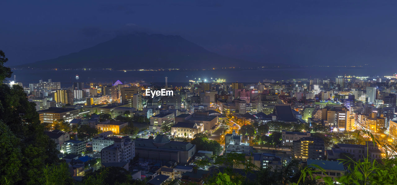 High angle view of city lit up at night