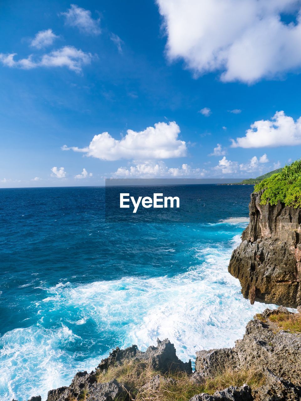 Scenic view of sea against blue sky