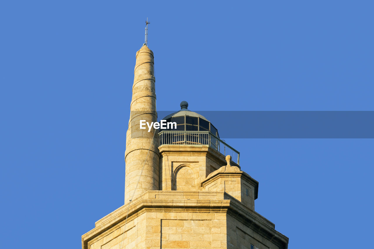 Tower of hercules against clear blue sky