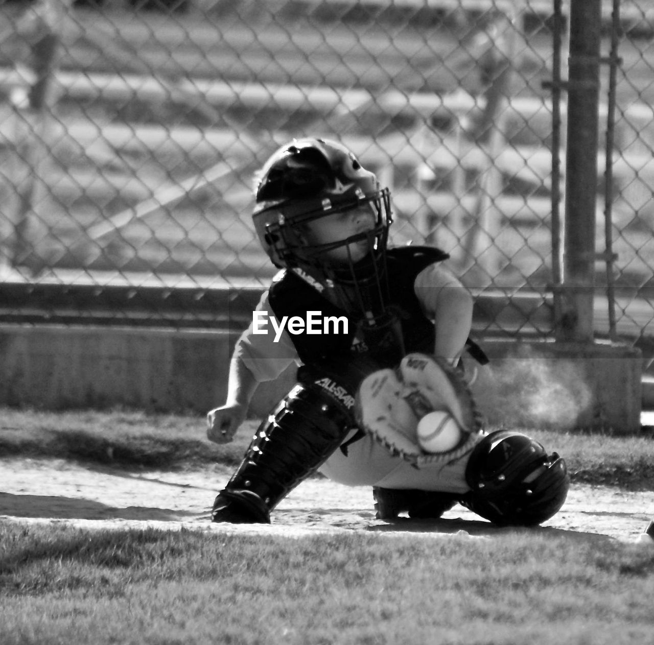 Hockey goalie in protective sportswear on playground