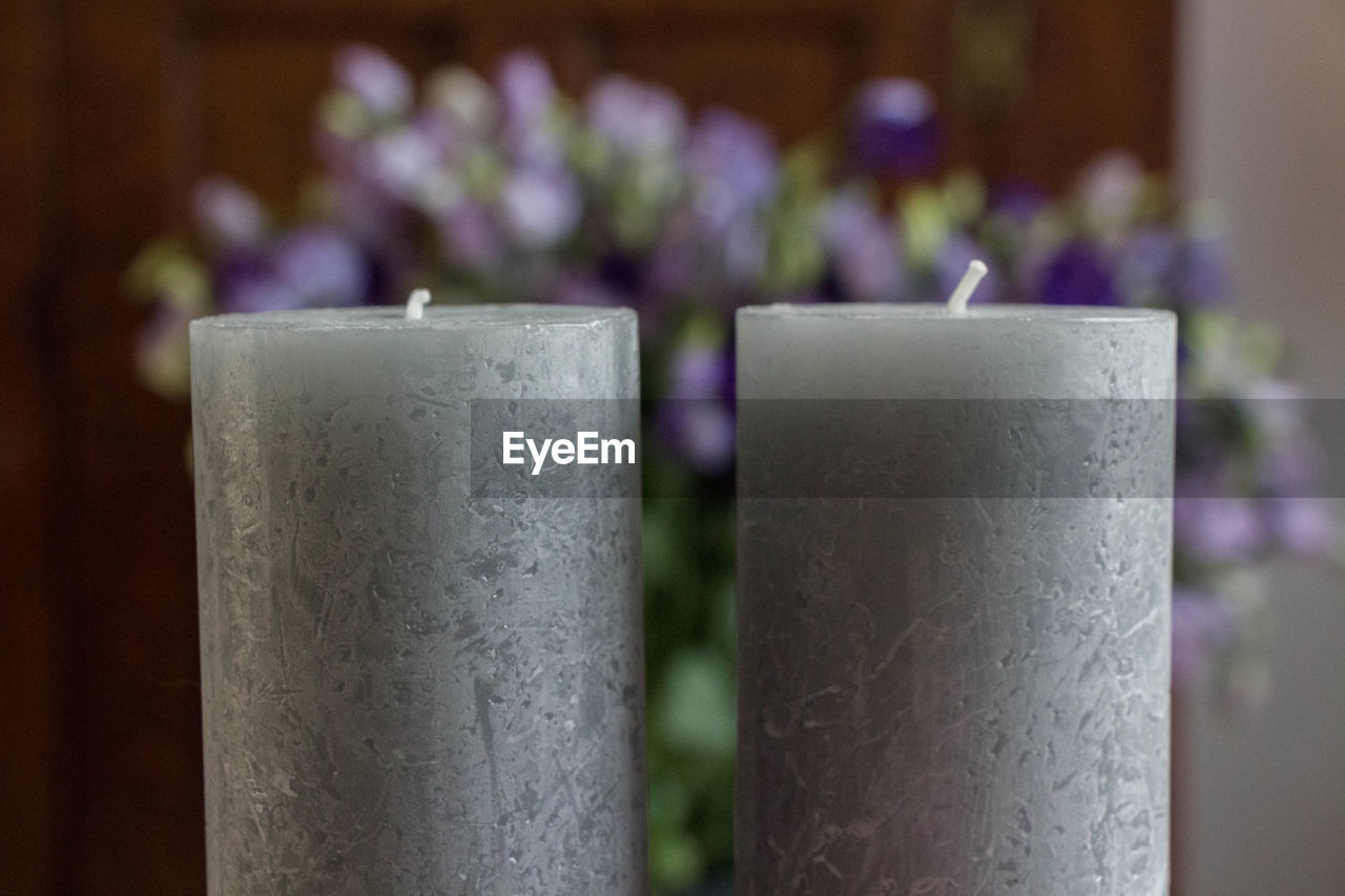 CLOSE-UP OF PURPLE FLOWER ON SHELF