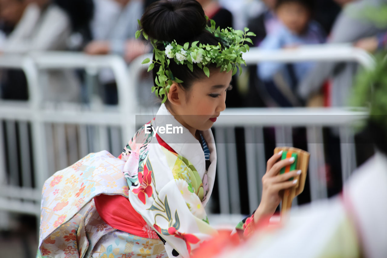 BOY USING MOBILE PHONE IN TRADITIONAL CLOTHING