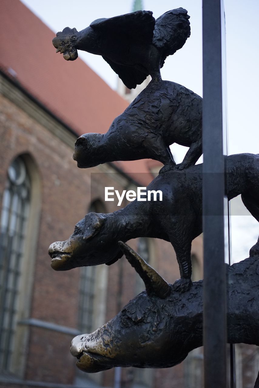 Low angle view of statue against building