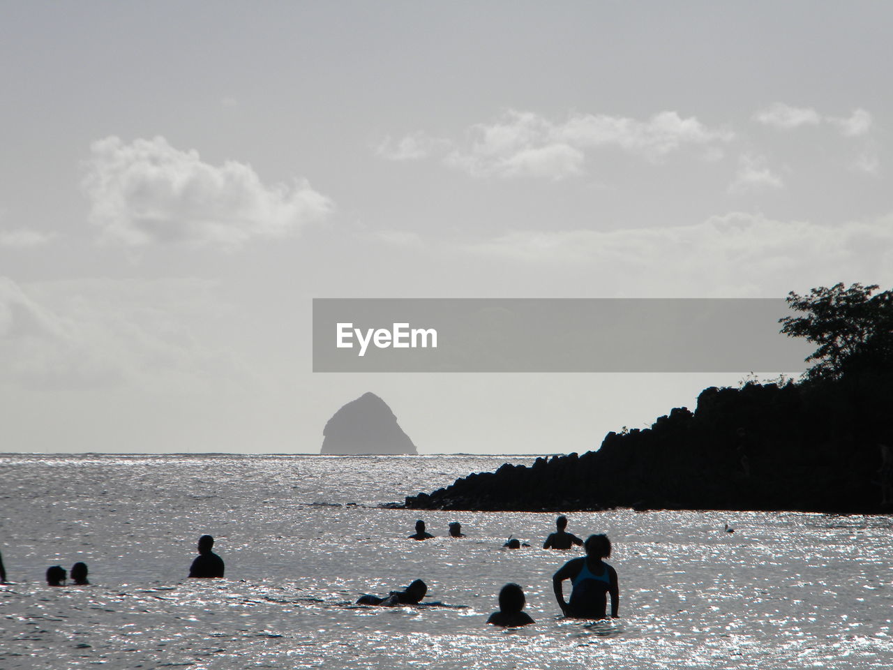 People enjoying in sea against sky