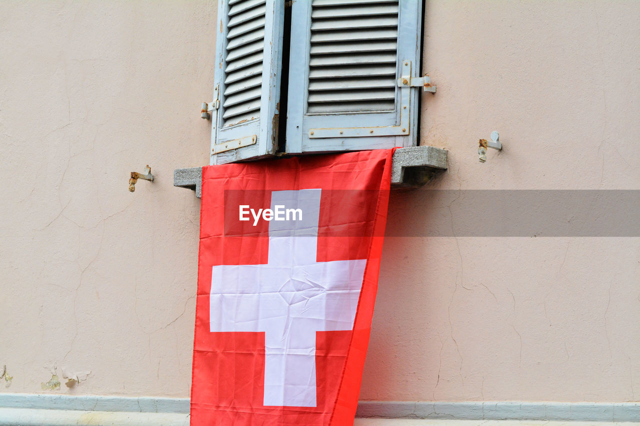 Swiss flag hanging from window