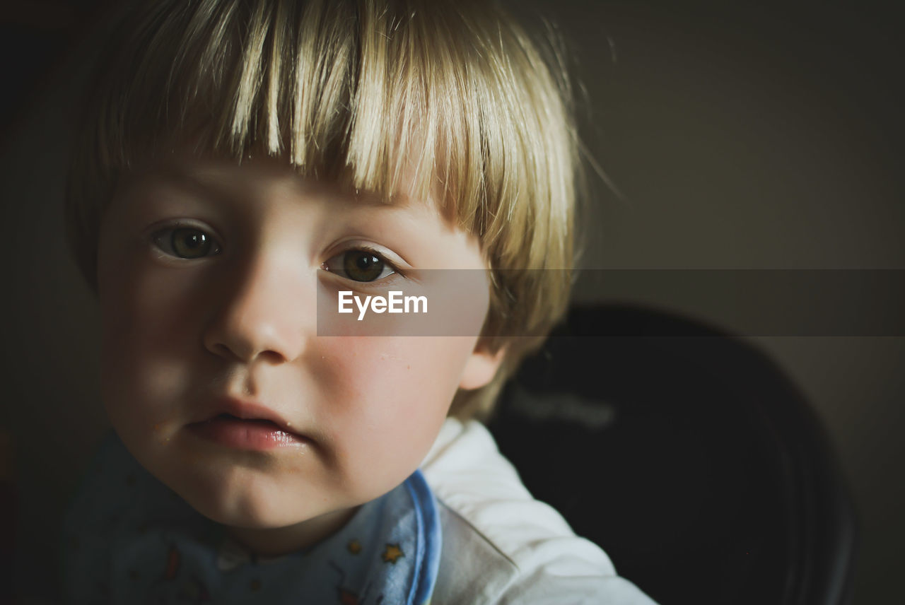 Close-up portrait of cute boy at home