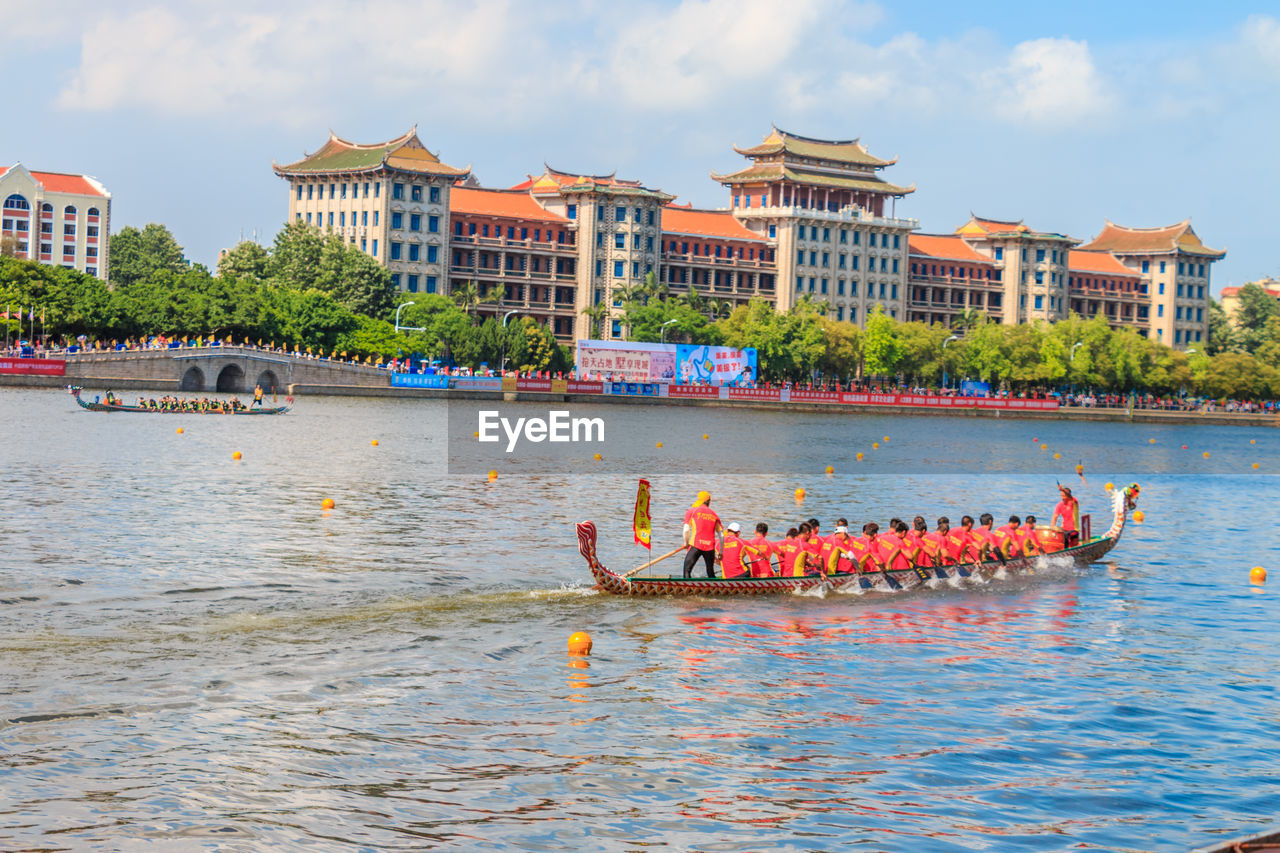 Boats in river with buildings in background