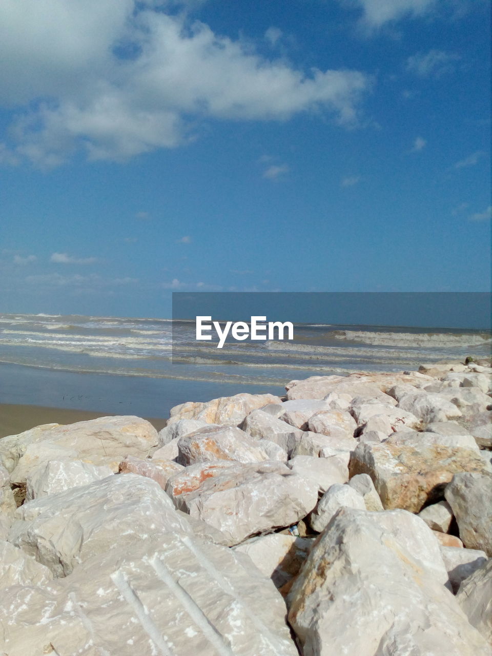 Rocks on beach against sky