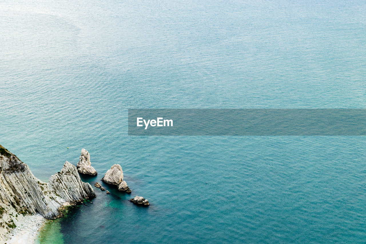 High angle view of rocks in sea