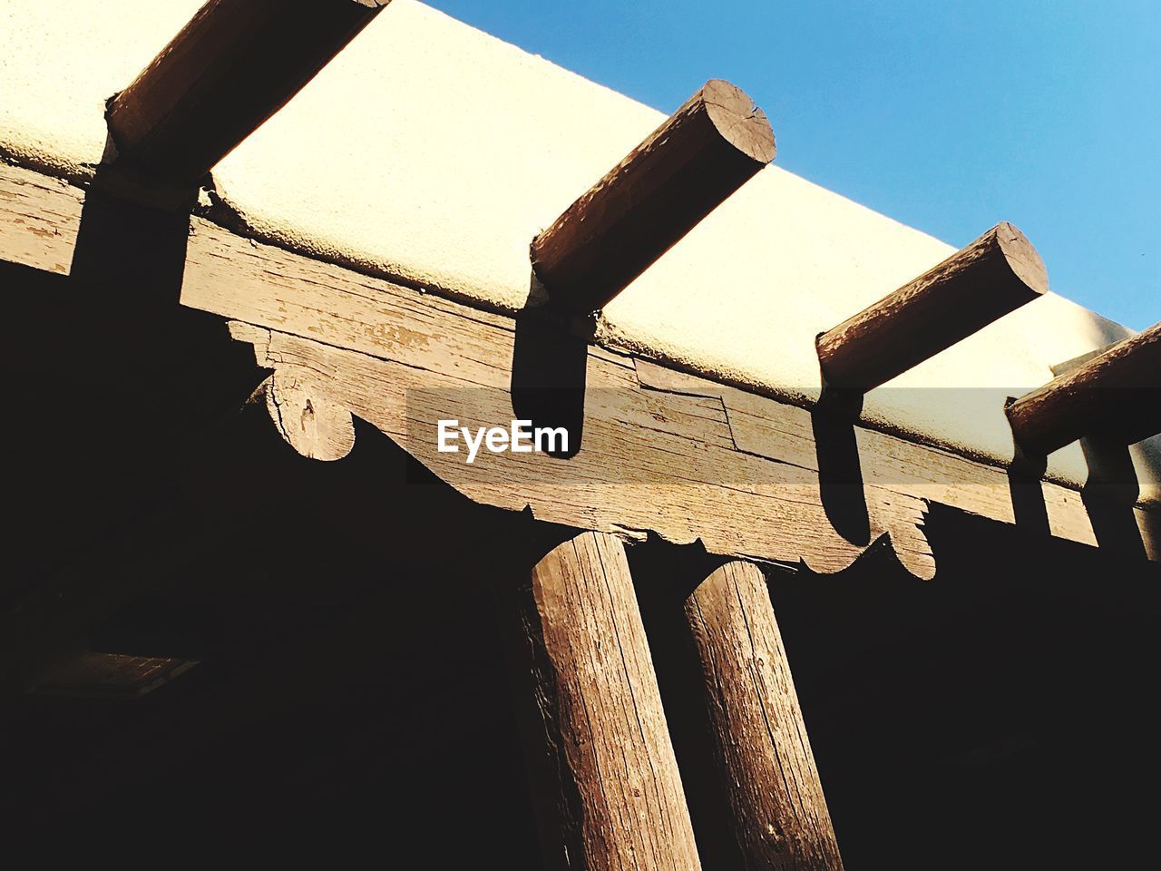 Low angle view of wooden pole against clear sky