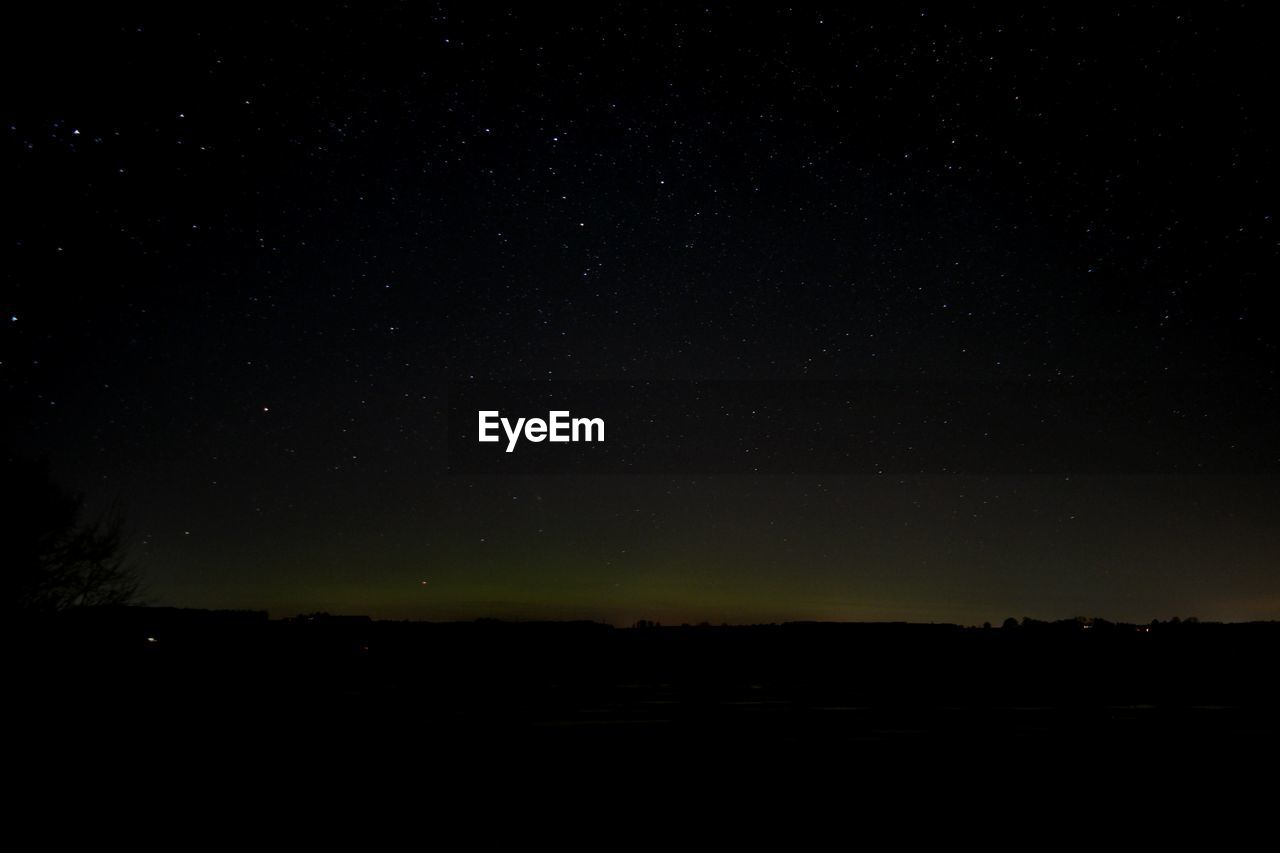 SILHOUETTE LANDSCAPE AGAINST SKY AT NIGHT