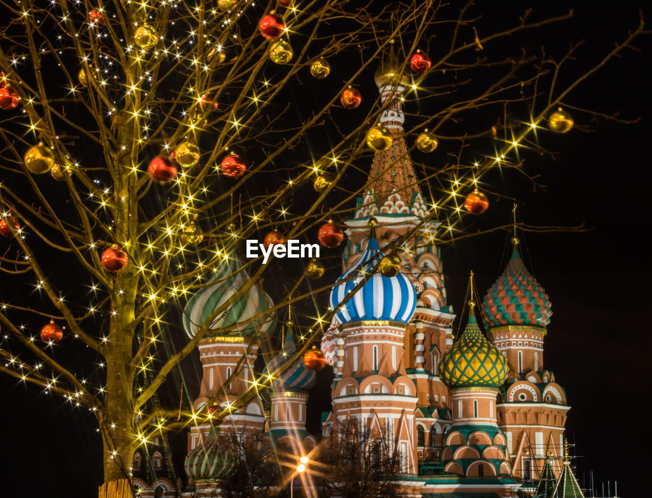 Low angle view of illuminated christmas lights at night